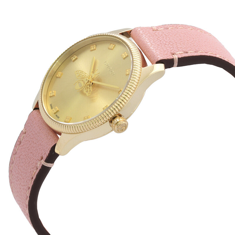 Gucci G-Timeless watch at angle showing pink leather strap and yellow gold case