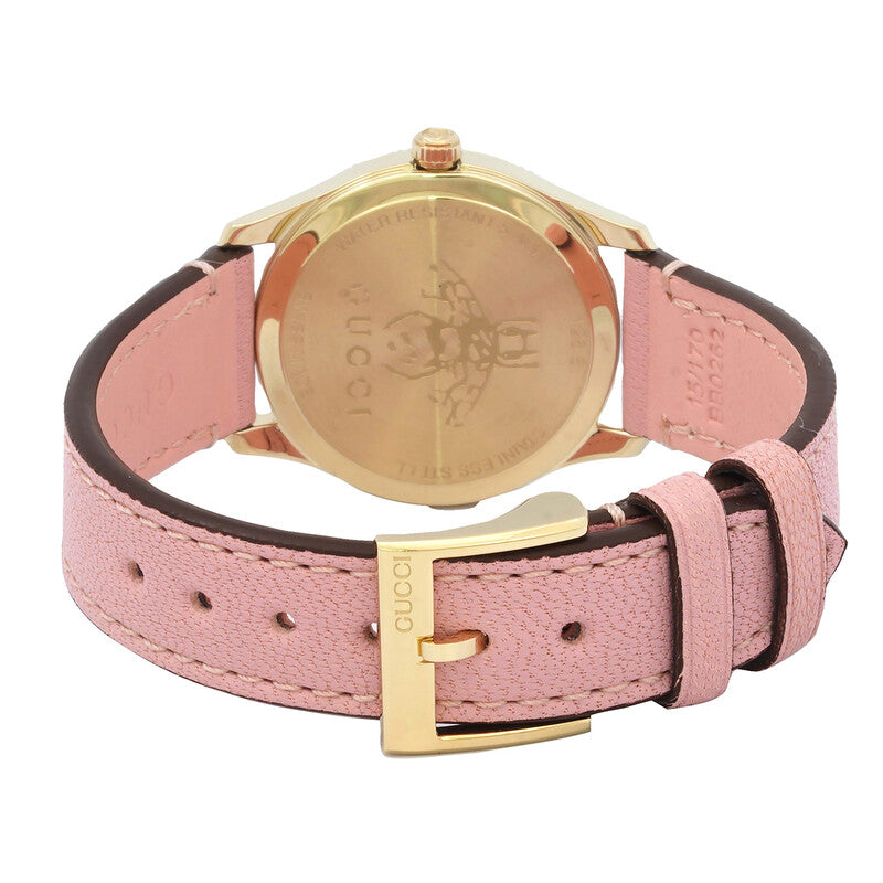 Gucci G-Timeless watch caseback view showing yellow gold case, pink leather strap, and gold buckle