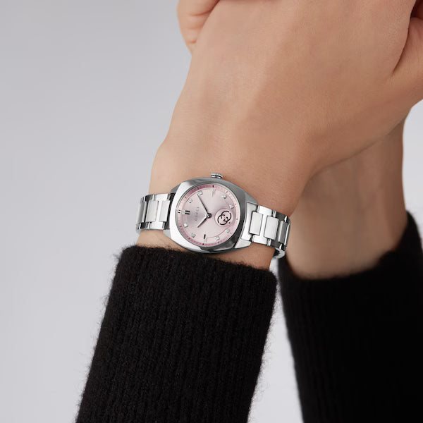 Gucci Interlocking ladies watch worn on wrist, pink dial with stainless steel case and bracelet