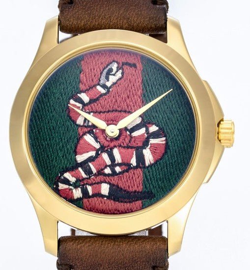 Angled view of Gucci Le Marche Des Merveilles watch with snake motif dial