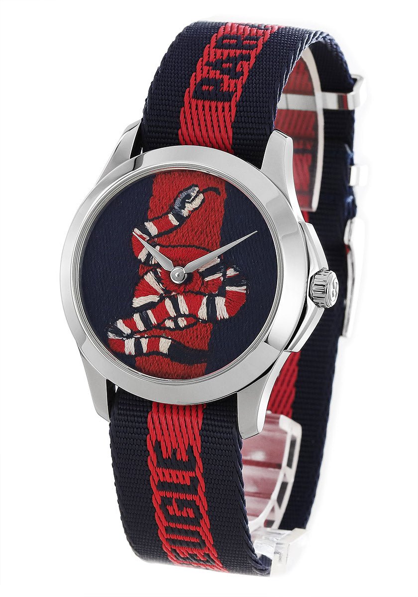 Gucci Le Marche Des Merveilles watch worn on wrist with striped nylon strap visible