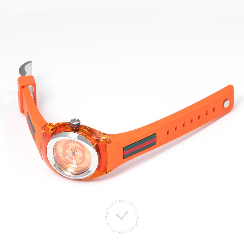 Gucci Sync watch worn on wrist, orange rubber strap with red stripe detail