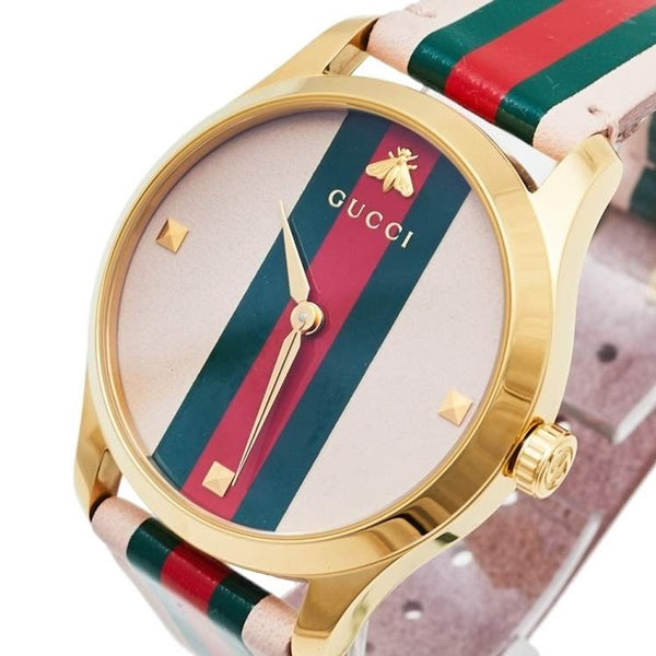 Gucci G-Timeless watch angled view showing gold case profile and web striped leather strap