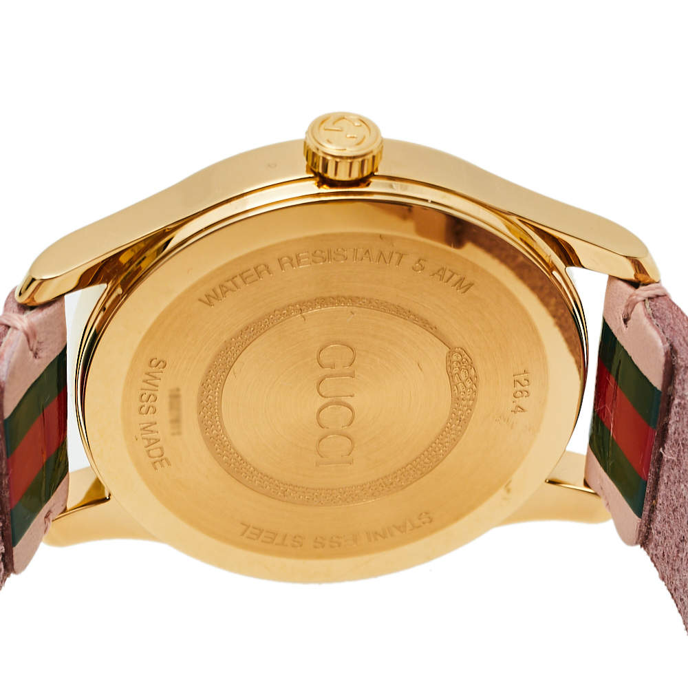 Gucci G-Timeless YA1264118 caseback showing gold plate with engraved logo and text