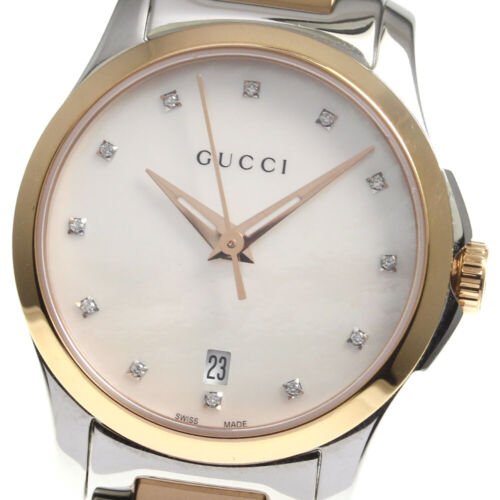 Close-up of Gucci G Timeless dial showing mother of pearl with diamond hour markers