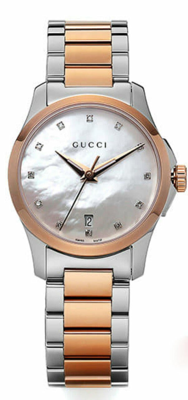 Full length view of Gucci G Timeless diamond watch with mother of pearl dial