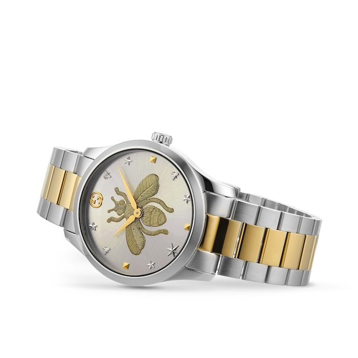 Gucci YA126599 G-Timeless women's watch on wrist showing bee dial and two-tone bracelet