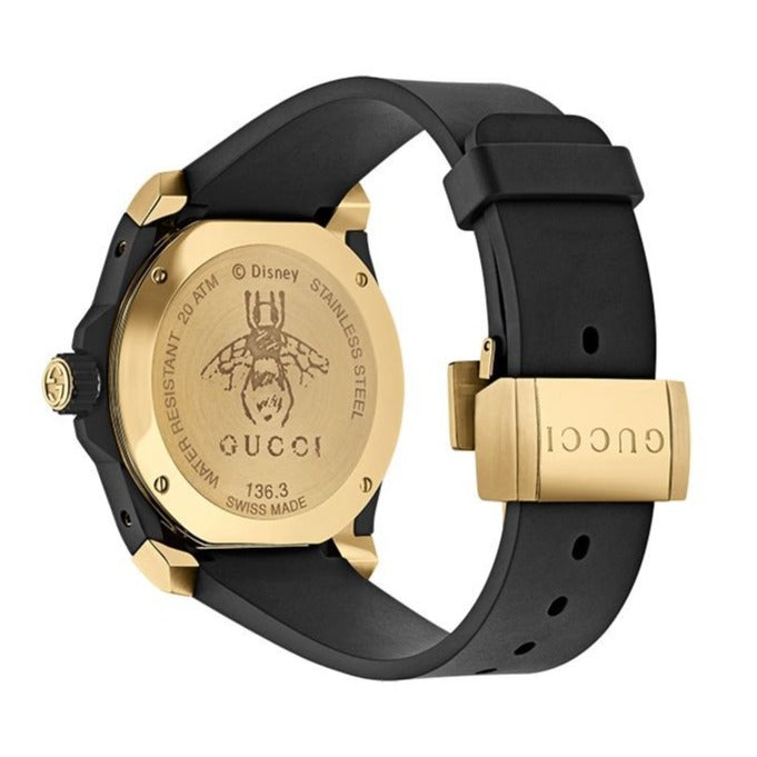 Gucci Dive watch caseback showing gold-tone case and black rubber strap
