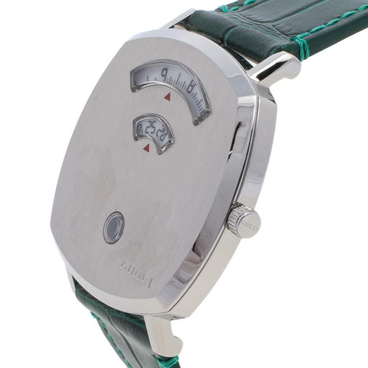 Gucci Grip watch side view showing silver case, gauge dial, and green leather strap