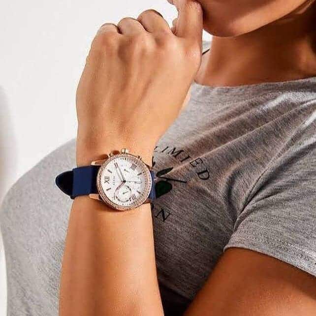 Guess 1135L3 chronograph watch on wrist showing rose gold case and navy strap