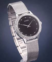 Angled view of Guess Chelsea Crystals watch showing black dial and silver mesh bracelet