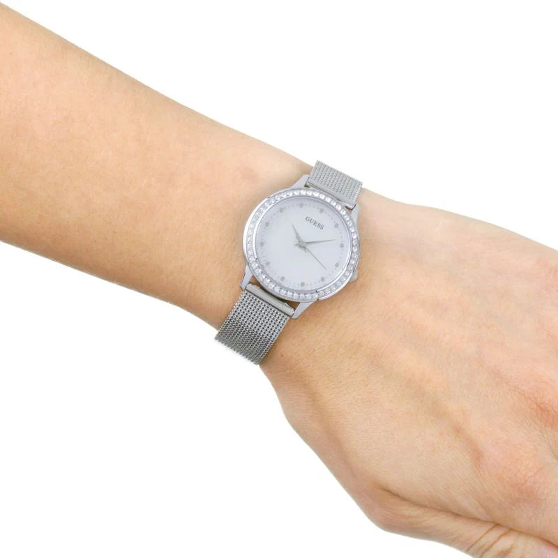 Guess Chelsea watch on wrist showing white dial and silver mesh bracelet