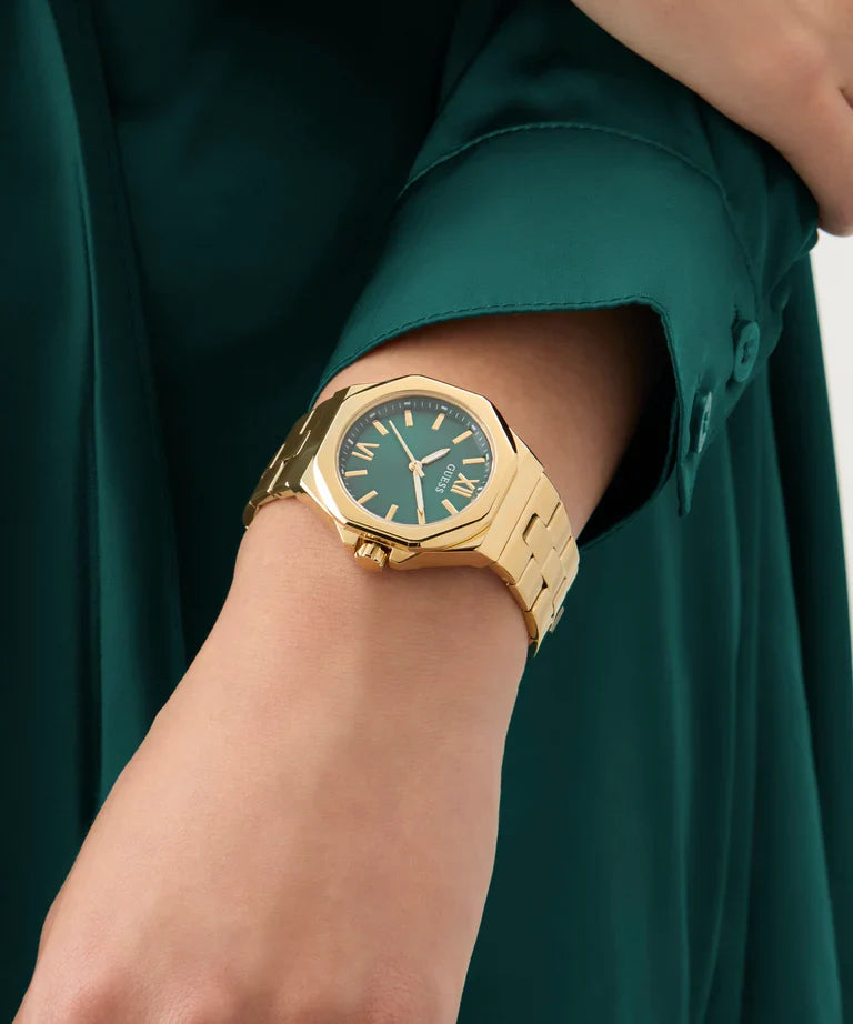 Guess Empress women's watch worn on wrist with teal dial and gold case
