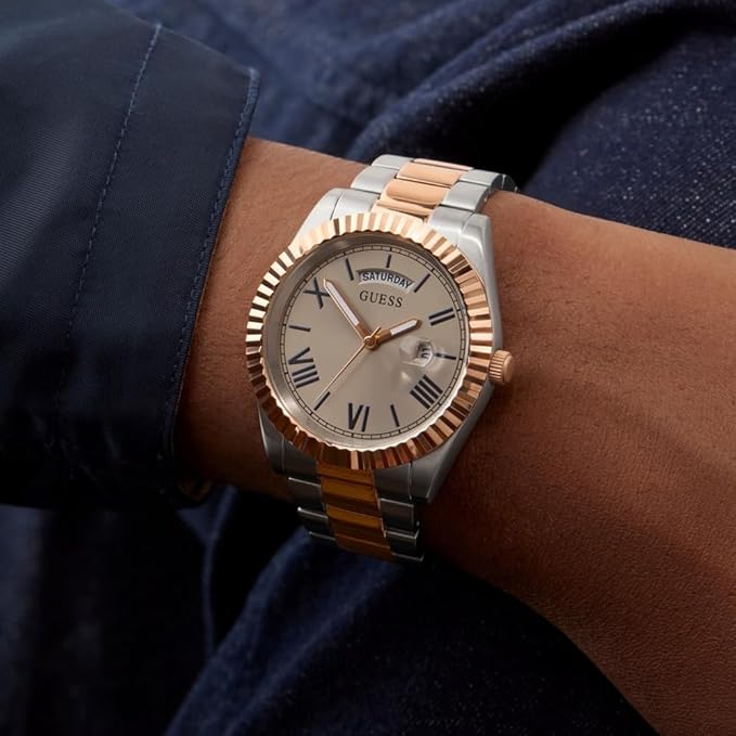 Two-tone GUESS GW0265G13 watch on wrist showing silver and rose gold bracelet and fluted bezel detail