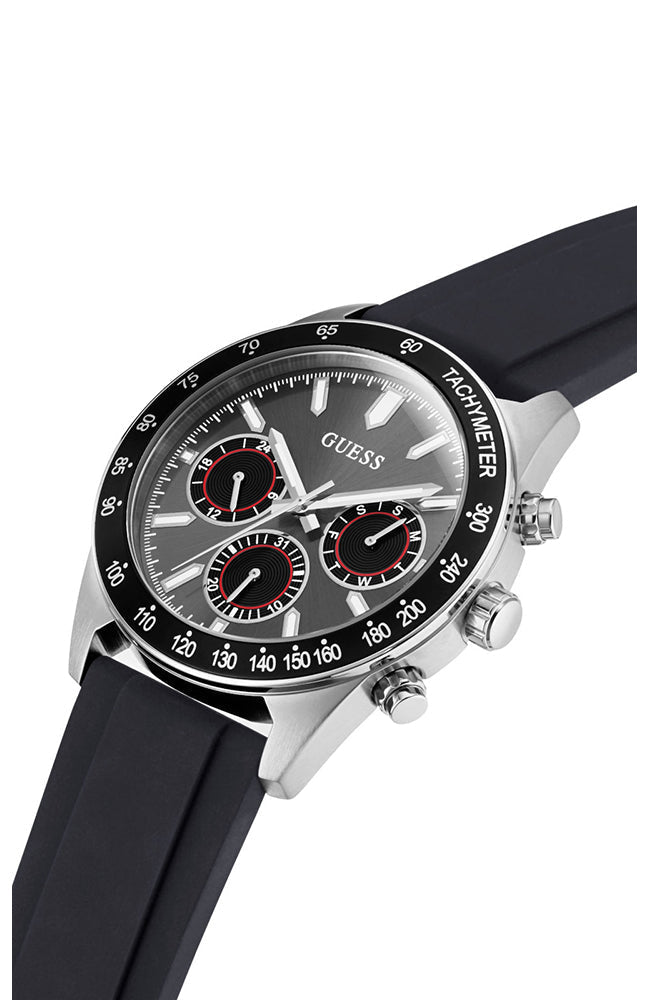 Angled view of Guess chronograph watch showing silver case, black silicone strap, and chronograph subdials