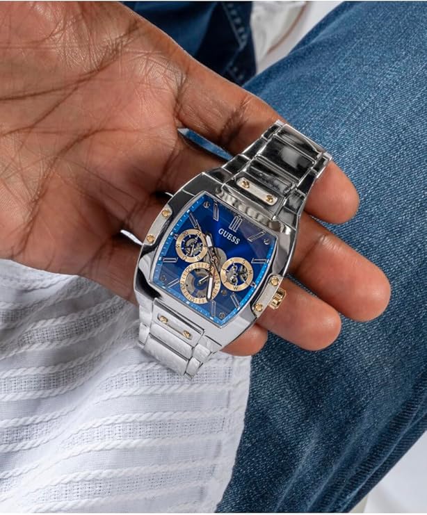 Guess GW0456G5 men's watch with blue dial held in hand, close-up view