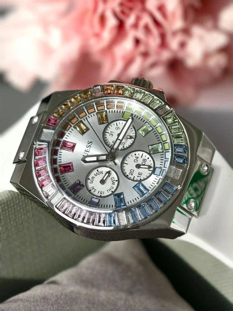 Guess GW0541L1 multicolor crystal bezel chronograph watch worn on white strap, angled view