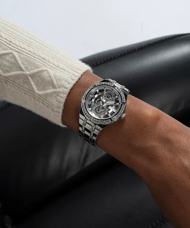 GUESS GW0604L1 silver tone watch worn on wrist with cream cardigan