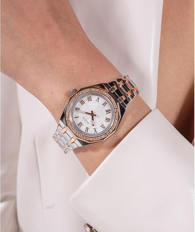 GUESS 2-tone ladies watch worn on wrist with white outfit