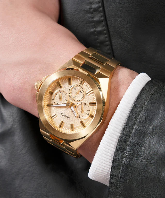 GUESS gold tone chronograph watch worn on wrist showing case profile and gold bracelet fit