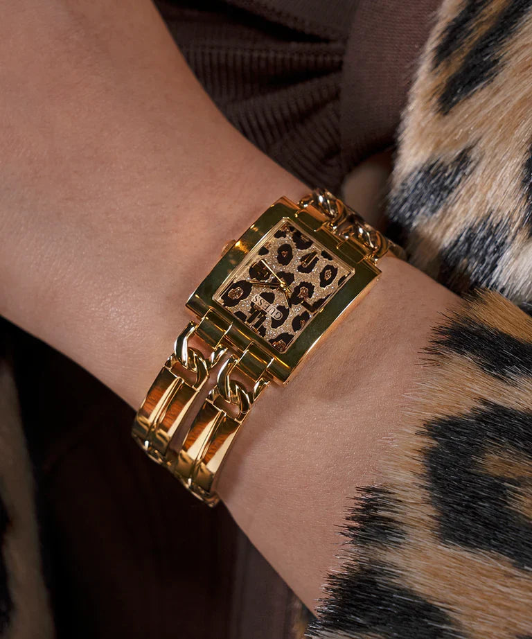 GUESS GW0807L2 gold tone watch worn on wrist with leopard print dial