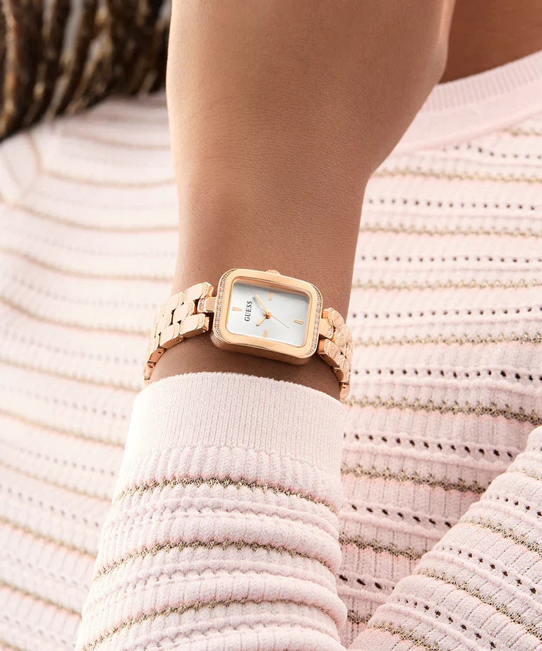 GUESS rose gold ladies watch on wrist with rectangular dial and crystal bezel