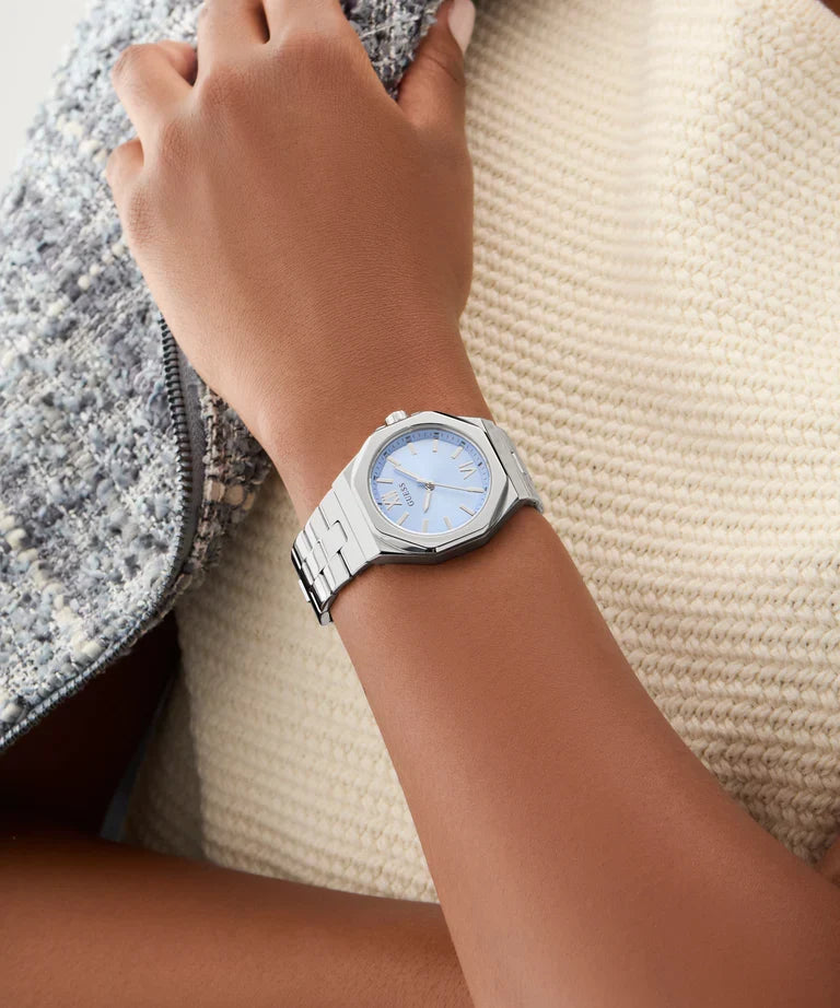 GUESS GW0873L1 women's watch worn on wrist with silver-tone case and blue dial