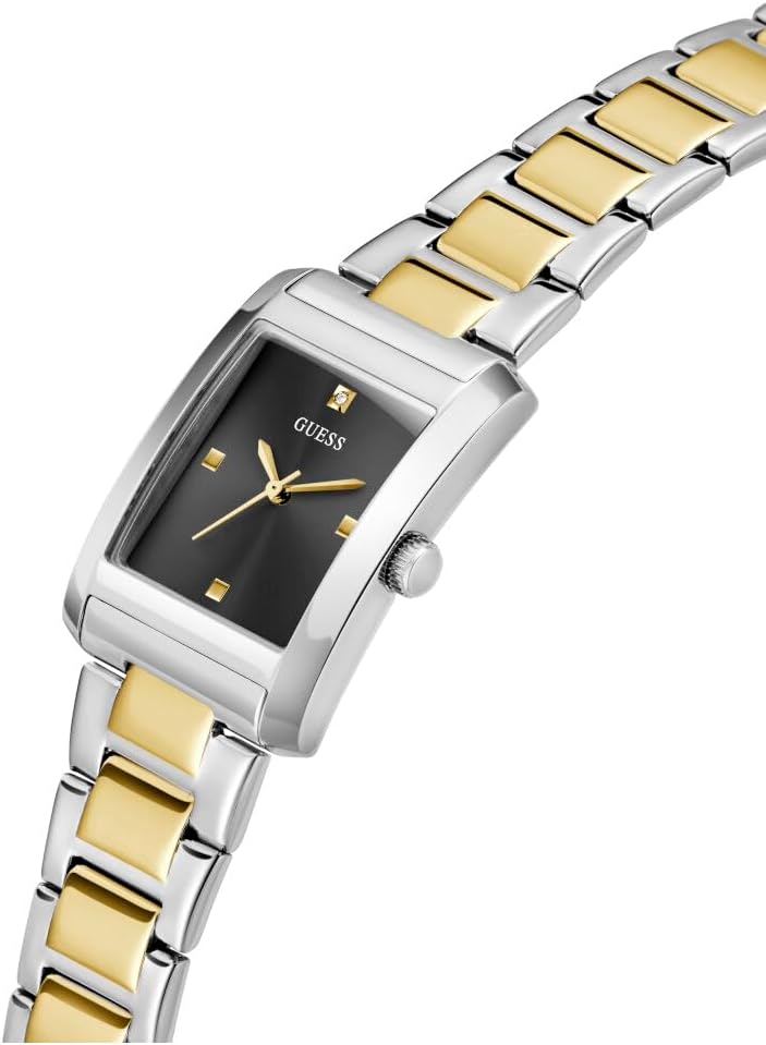 GUESS square watch at angle showing black dial, gold hour markers, and two-tone band