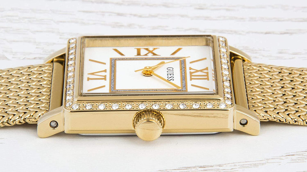 Guess Highline watch worn on wrist with off-white dial and gold-tone textured mesh band