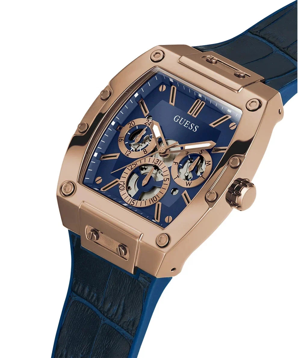 Guess Phoenix watch worn on wrist with blue silicone strap and rose-gold case