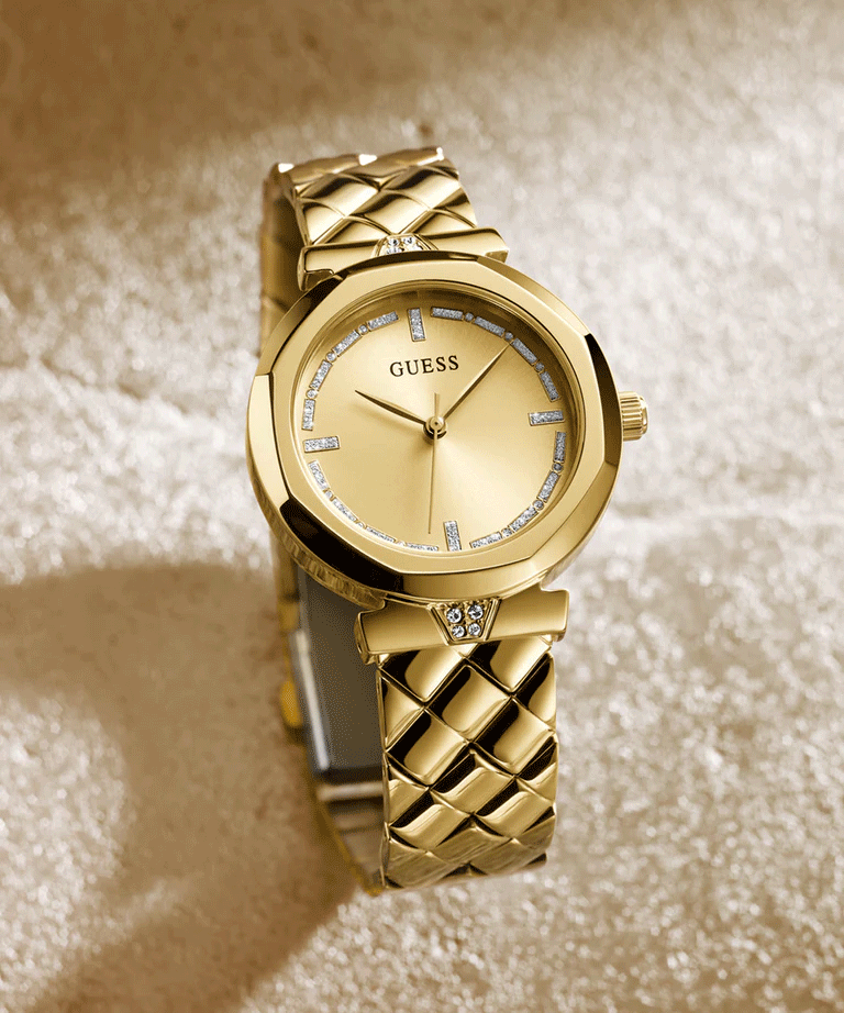 Guess Rumour gold women's watch on wrist with quilted strap
