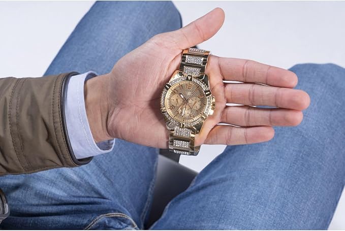 GUESS W0799G2 gold chronograph watch on wrist held in hand, front view