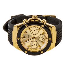 GUESS GW0030L2 gold chronograph watch with black rubber strap worn on wrist