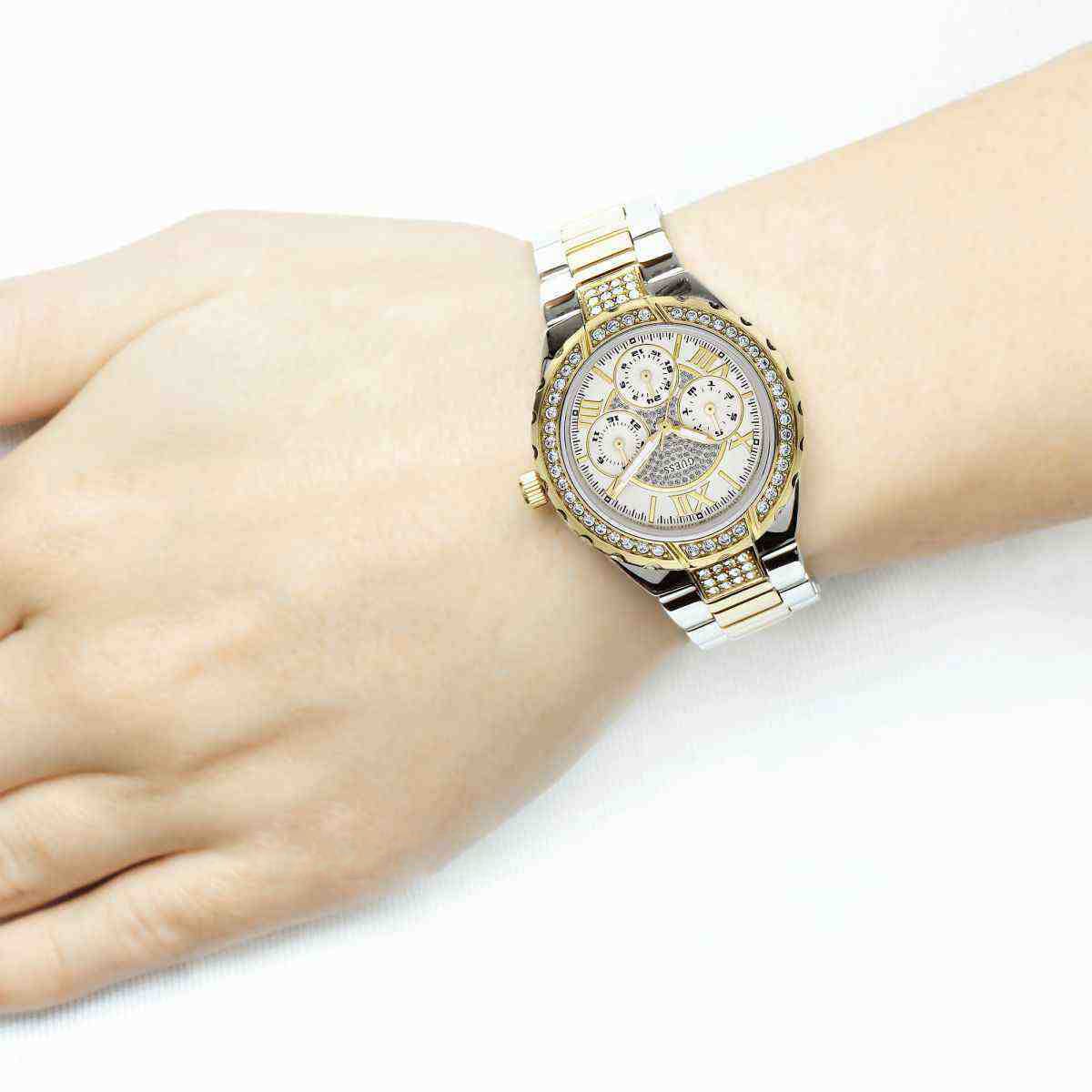 GUESS GW0111L5 women's watch on wrist showing silver dial and two-tone bracelet