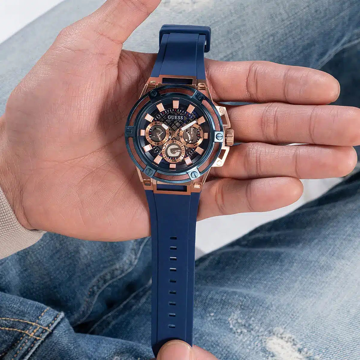Guess Matrix watch in hand showing blue dial, rose gold case and strap