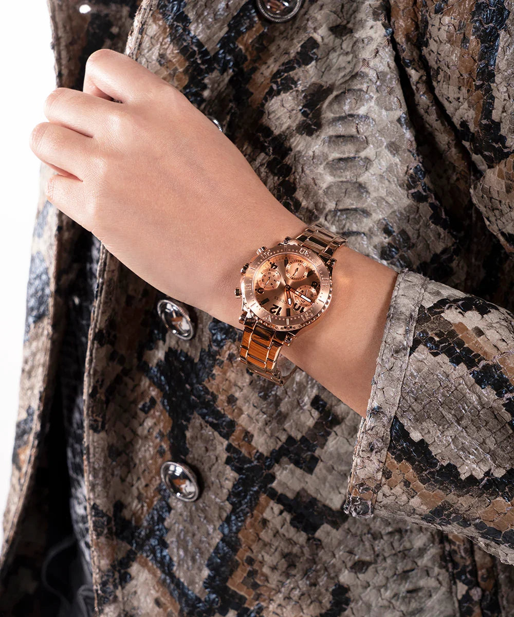 Guess Cosmic rose gold watch styled on wrist with snake print jacket