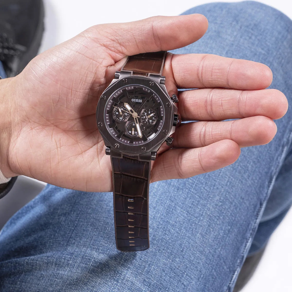 Guess Edge chronograph watch worn on wrist showing brown dial and leather strap