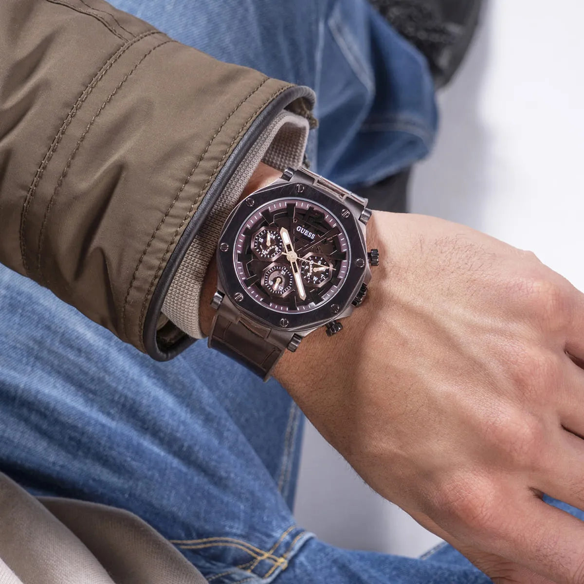 Guess Edge chronograph men's watch on wrist with brown leather strap and brown dial