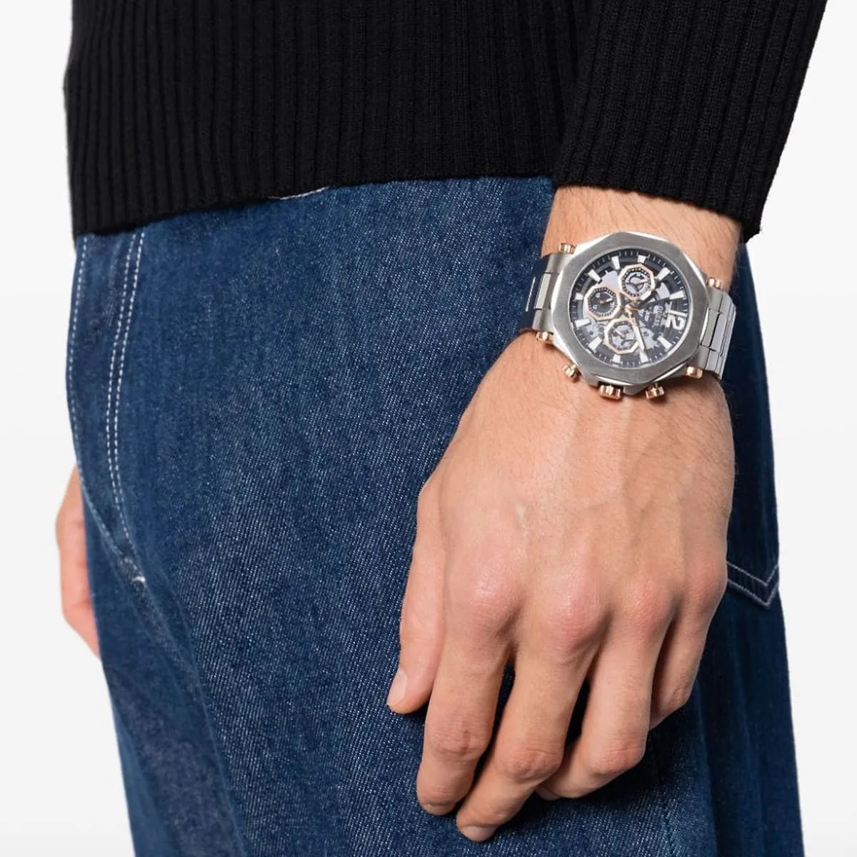 Guess GW0539G1 chronograph watch worn on wrist showing black dial with rose gold accents and metal bracelet