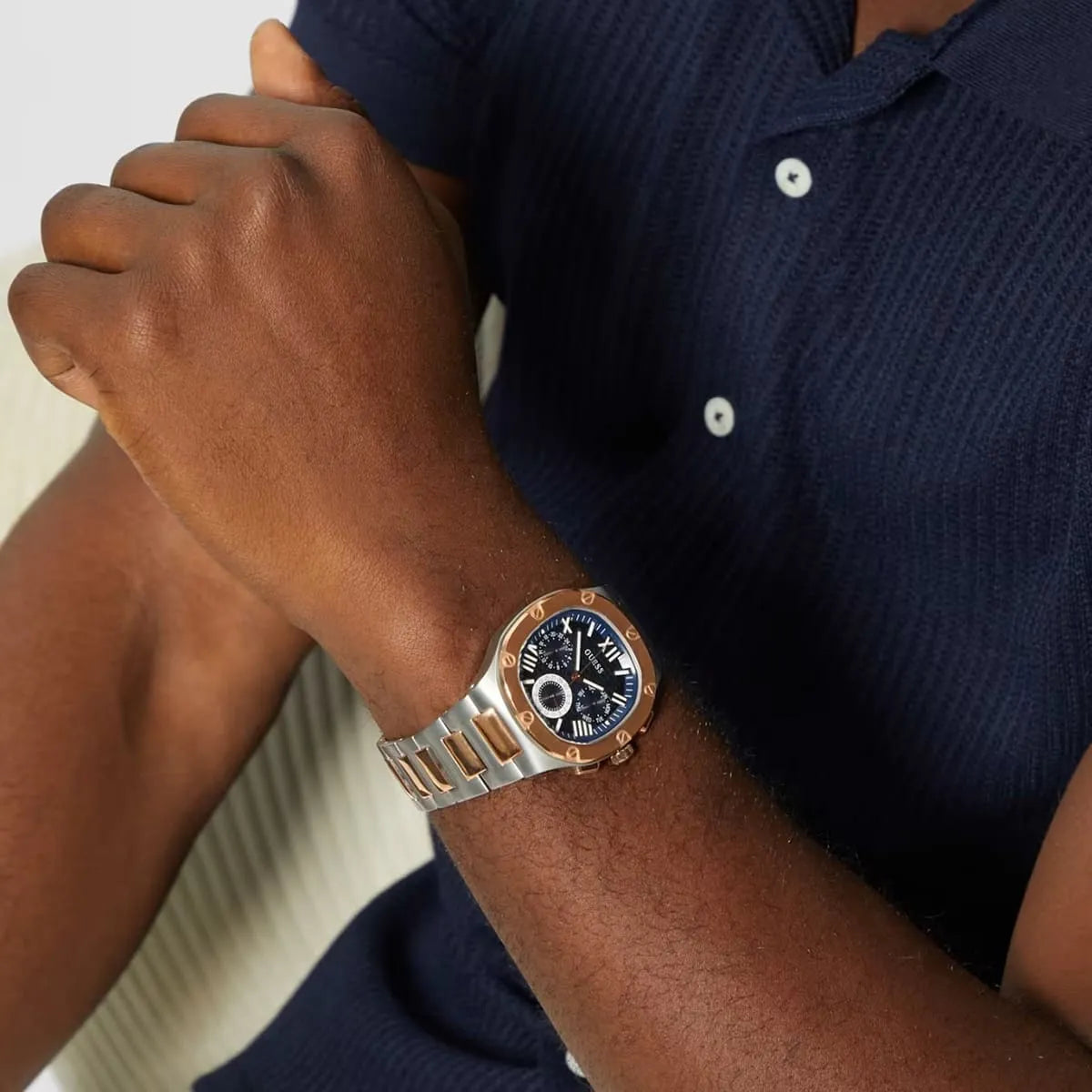Guess Headliner watch worn on wrist, showing blue dial and two-tone design
