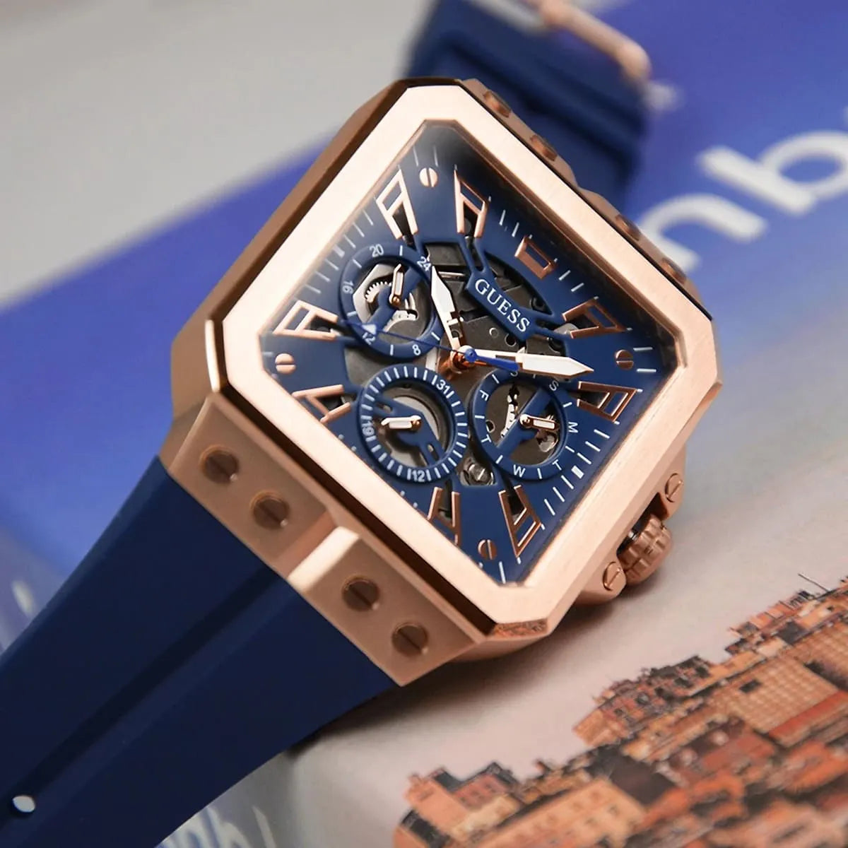 GUESS GW0637G3 blue dial close-up with white hands and gold chronograph subdials