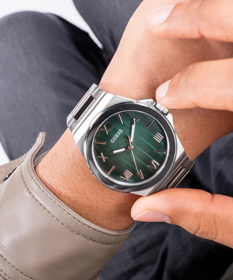 GUESS GW0789G1 watch worn on wrist with green dial and silver stainless steel case