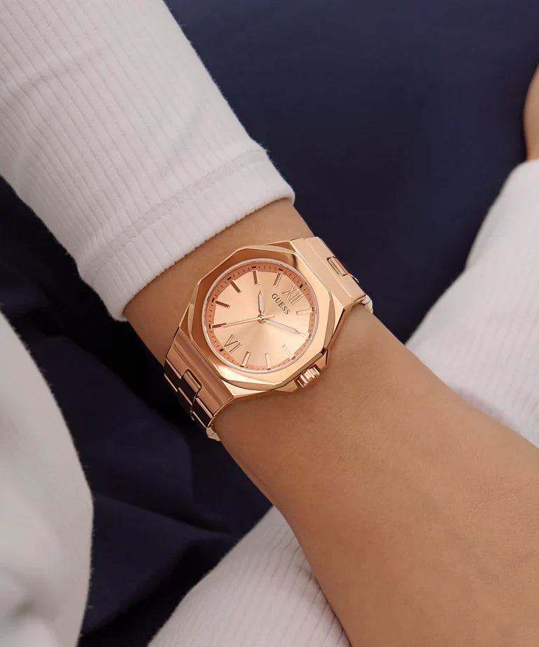 Guess Empress rose gold watch worn on wrist with white and navy outfit