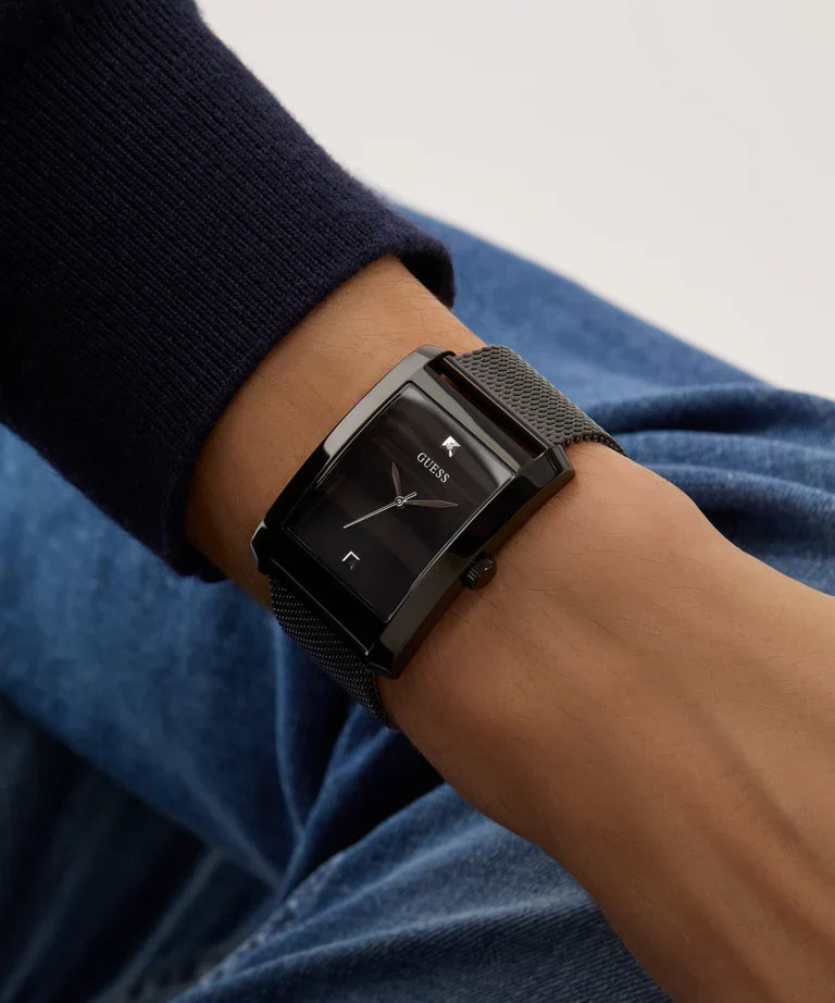 GUESS black watch worn on wrist with dark blue and light colored sleeve