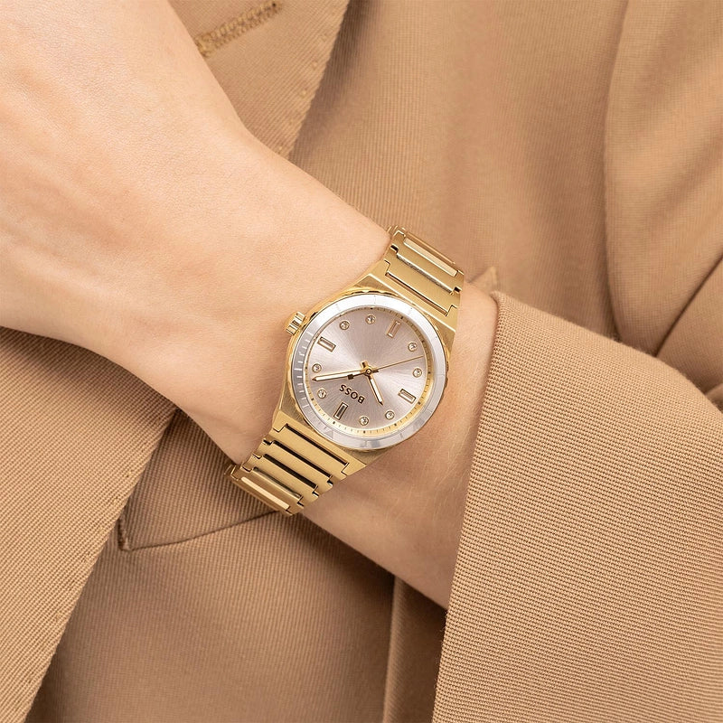 Hugo Boss Candor Sport gold watch worn on wrist with gold bracelet strap