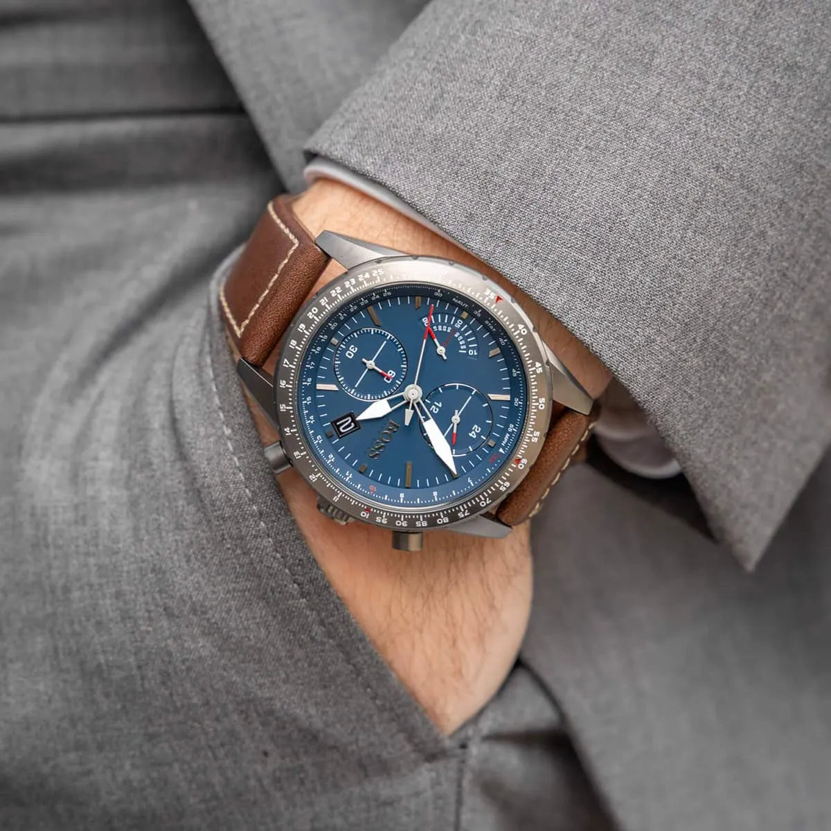 Hugo Boss Pilot chronograph watch worn on wrist with blue dial and brown leather