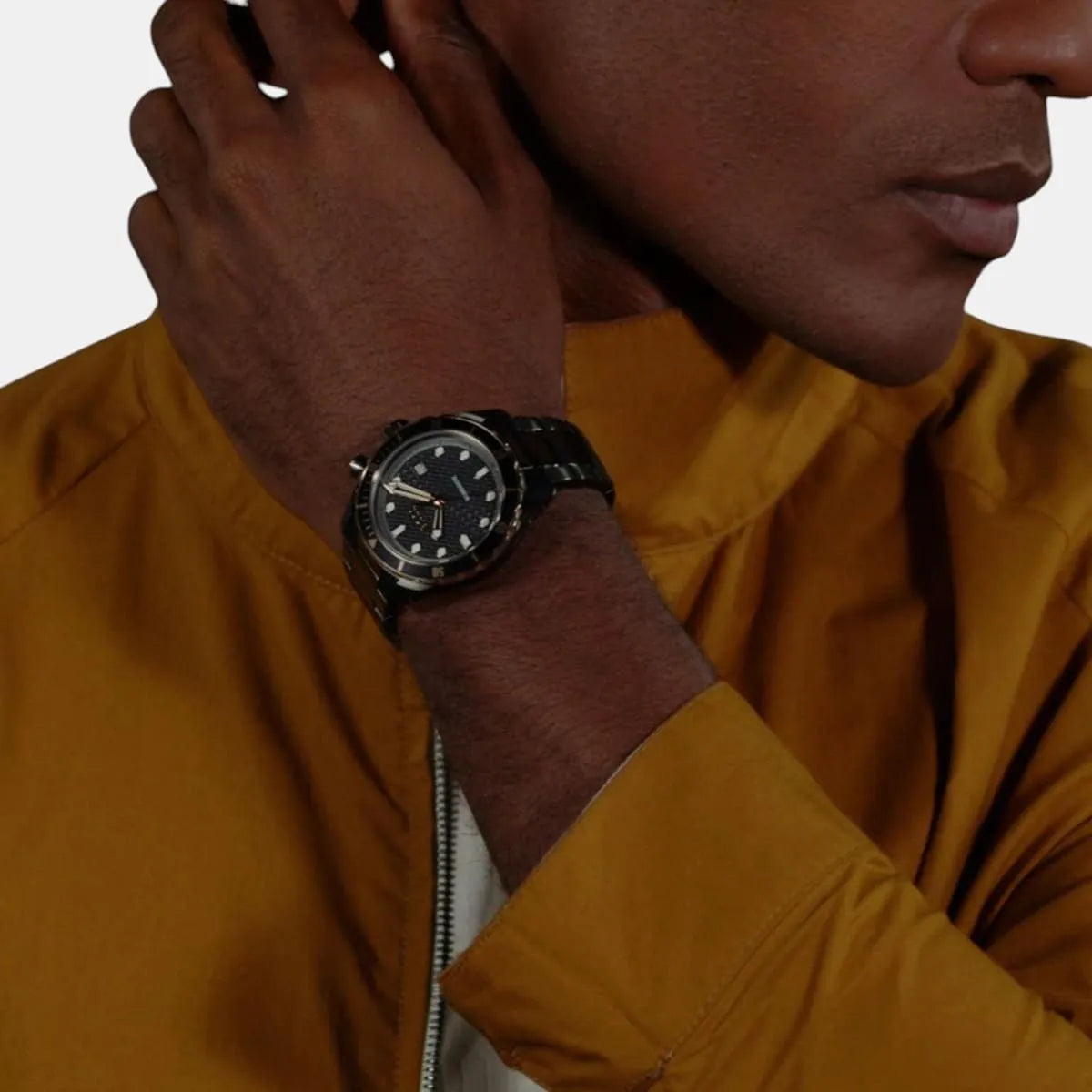 HUGO BOSS Bossmatic watch worn on wrist against golden-yellow shirt sleeve