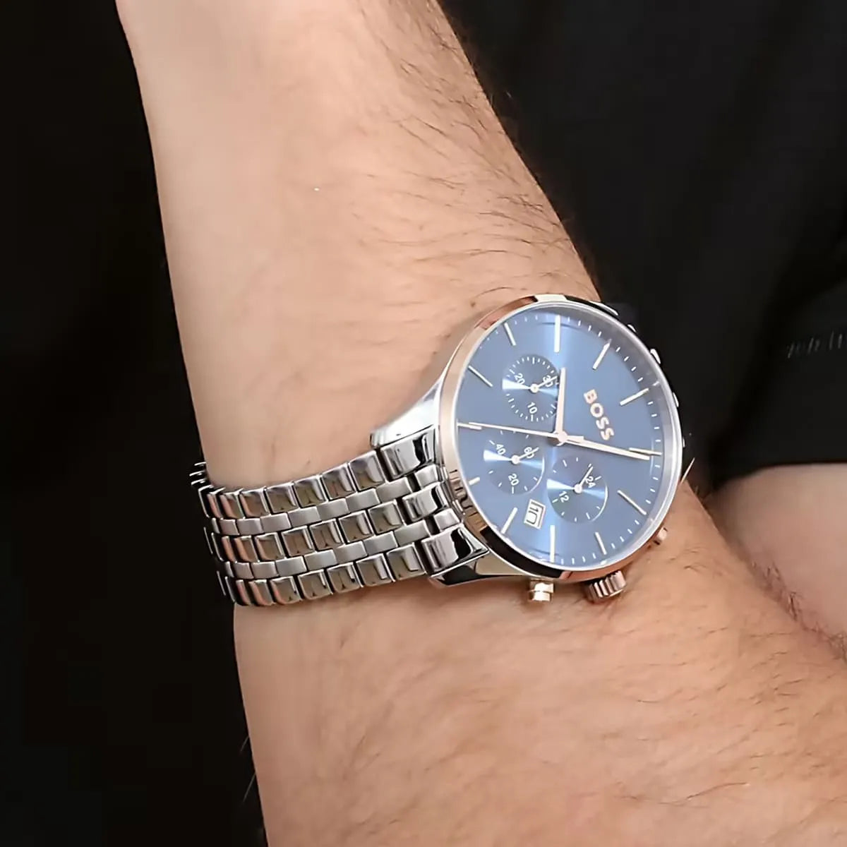 Hugo Boss Avery men's watch on wrist showing silver steel bracelet and blue dial with chronograph subdials