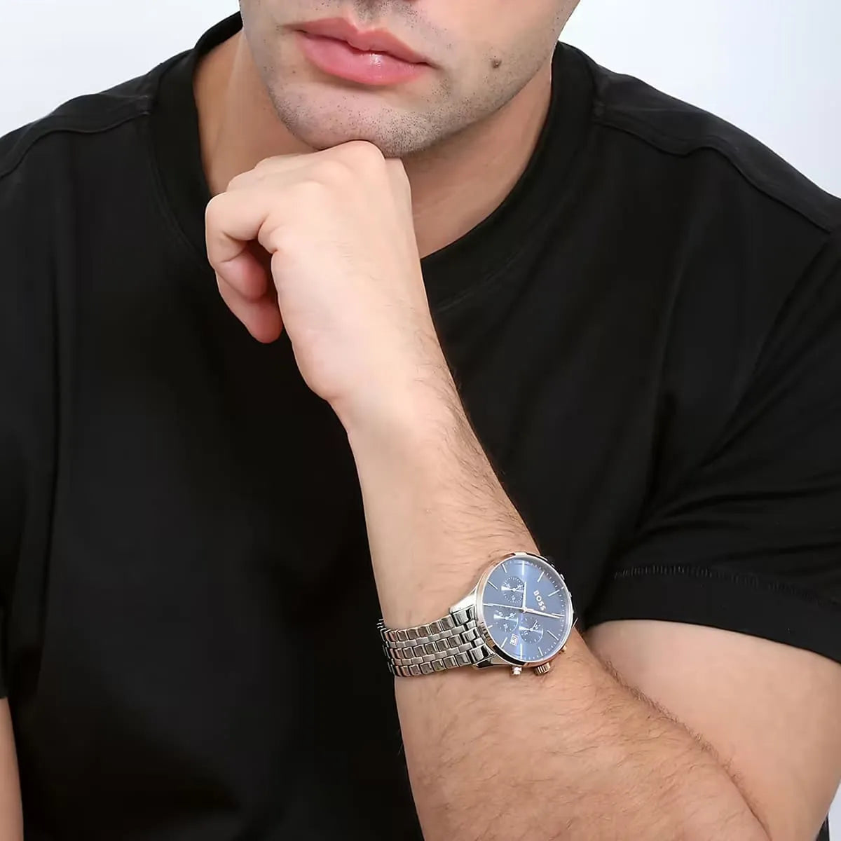 Hugo Boss Avery chronograph watch worn on wrist with blue dial and rose gold pushers