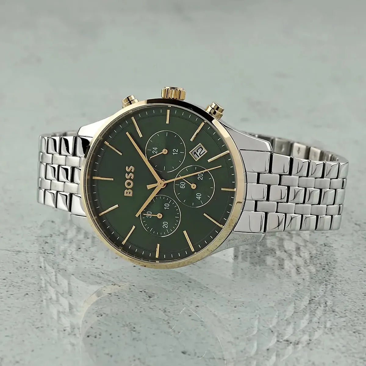 Hugo Boss Avery chronograph watch with green dial and stainless steel bracelet on gray surface